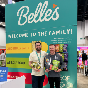 Belle's Popcorn. exhibitor at 2025 sweets and snacks. photo with onsite exhibitor engagement manager from map your show. event management technology
